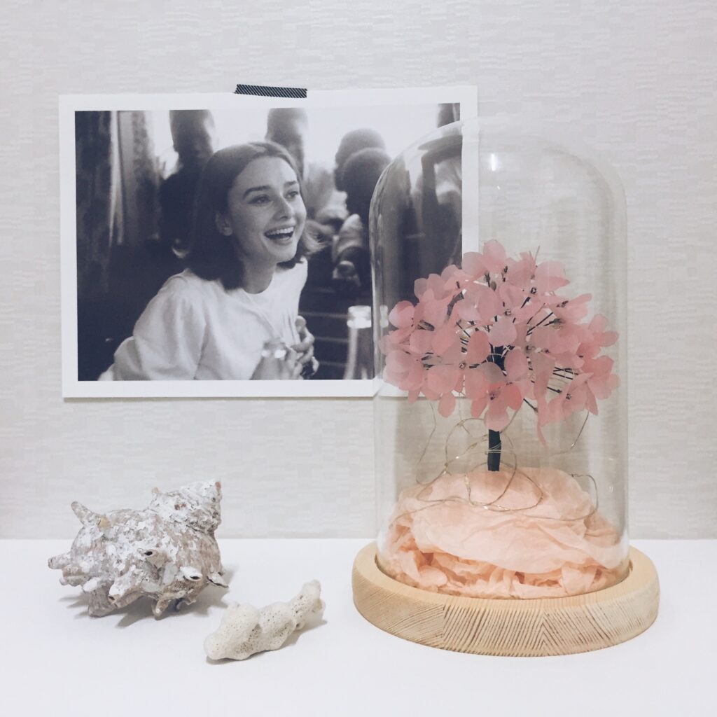 paper flower care tips displaying in a glass dome
